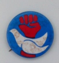 Item #018430 Anti-War Pinback with White Dove in front of a raised red Fist